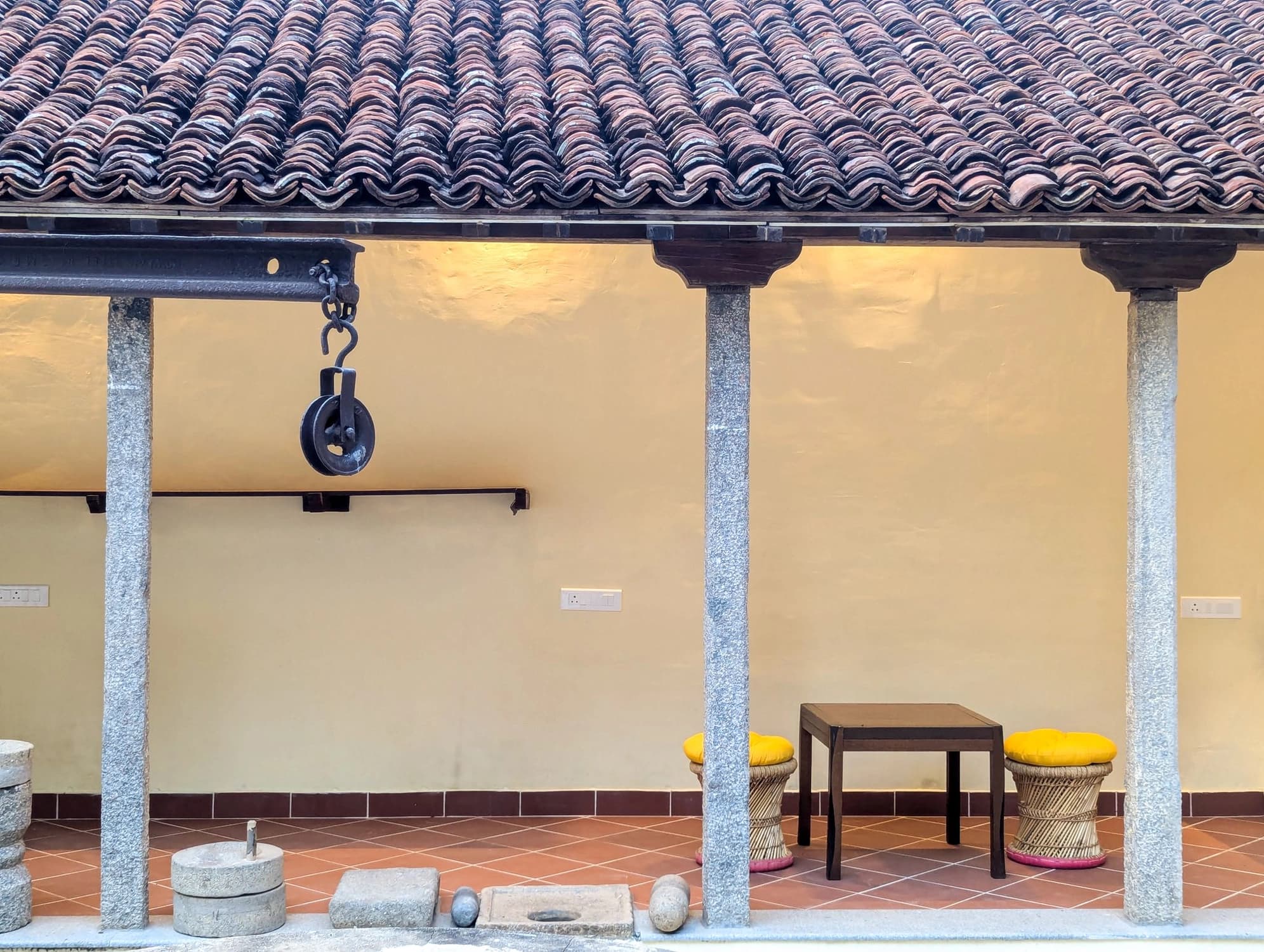 xl_25. Thinnai 4- Ancient Indian kitchen equipment and traditional architecture define this quiet corner of Shruti's verandah, echoing its rich past.