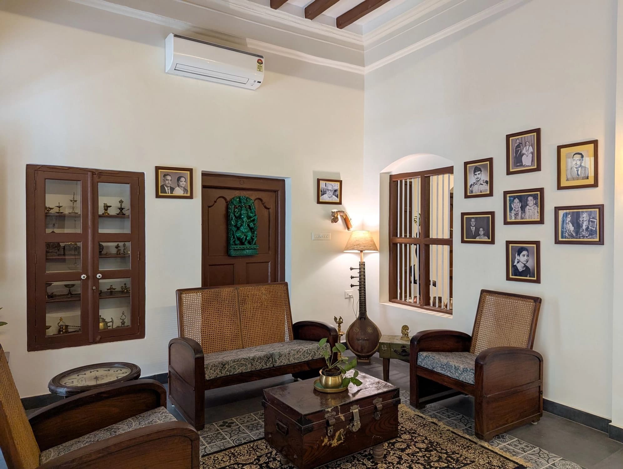 xl_Lobby 2- The lobby is adorned with framed family wedding photos and Unique decor includes a vintage veena repurposed as a lamp base.